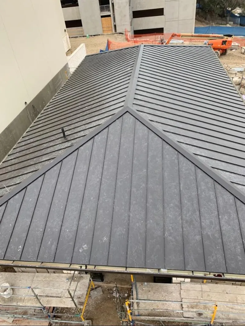 Commercial metal roof construction with crane equipment in Almena